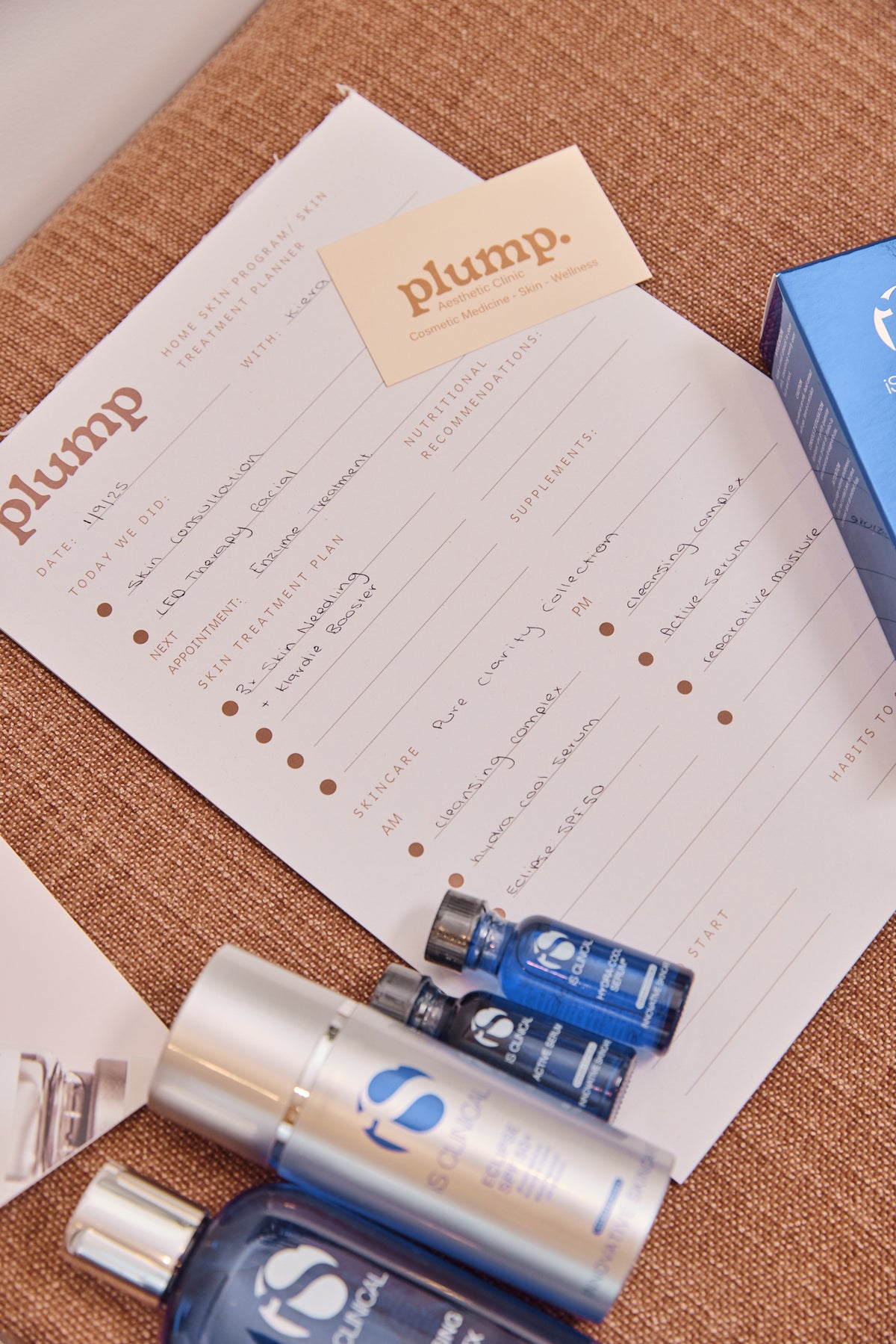 iS Clinical skincare laid out on a Plump Aesthetic Clinic treatment plan in clinic
